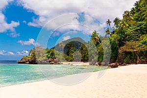 Beautiful landscape of tropical beach, rocks with vegetation, sea and white sand. Summer vacation concept