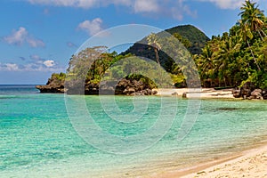 Beautiful landscape of tropical beach, rocks with vegetation, sea and white sand. Summer vacation concept