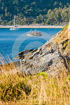 Beautiful Landscape and Tropical over the blue sea and Cape with fishing boat, Yacht or sailboat in the background and rock cape f