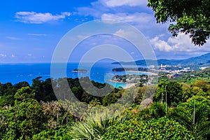 Beautiful landscape of turquoise ocean waves with boats, coastline and blue sky background from high aerial view point