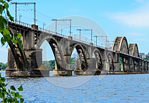 Beautiful landscape of the Ukrainian  Dnipro city with old arch railway Merefo-Kherson bridge across the Dnieper river