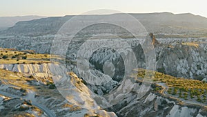 Beautiful landscape of valley at dawn or sunset. Unusual landscape of natural volcanic origin. Cliffs with caves