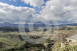 Beautiful landscape of the valley of Ronda with farmland and mountains in the background