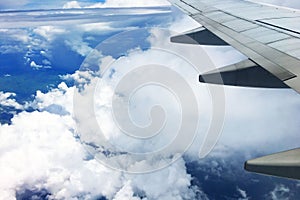 Beautiful landscape view background of sky above cloud  plane`s window and see plane`s wing