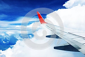 Beautiful landscape view background of sky above cloud  plane`s window and see plane`s wing