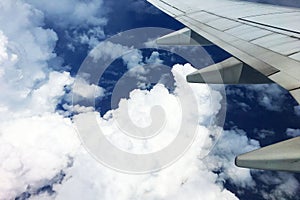 Beautiful landscape view background of sky above cloud  plane`s window and see plane`s wing