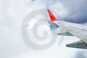 Beautiful landscape view background of sky above cloud  plane`s window and see plane`s wing