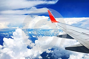 Beautiful landscape view background of sky above cloud  plane`s window and see plane`s wing