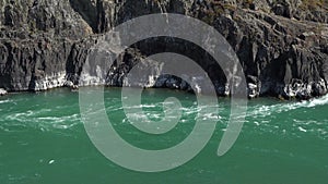 Beautiful landscape view of a big mountain river stream with high rocky banks.