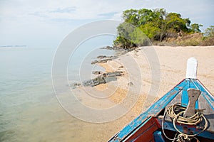 Beautiful landscape view of island with trees, sand and clear sea water which is viewpoint of traveller on traditional ship sees