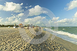 Beautiful landscape view of Miami South  Beach coast line. Sand beach, Atlantic Ocean, people and high buildings.