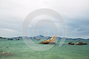 Beautiful landscape with view of ocean, perfect beach, big stones, trees, azure water. Background image. Concept travel