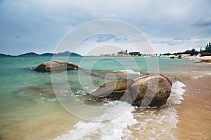 Beautiful landscape with view of ocean, perfect beach, big stones, trees, azure water. Background image. Concept travel