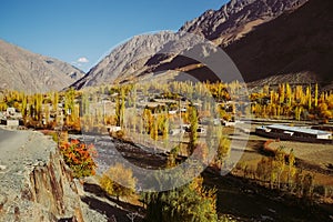 Small village in Gupis valley against Hindu Kush mountain range in autumn