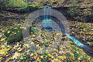 Beautiful landscape with a waterfall in the autumn forest. vintage effect. (harmony, meditation, anti-stress - concept)