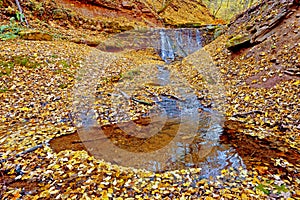 Beautiful landscape with a waterfall in the autumn woods. (Harmony, peace, meditation - concept)