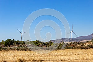 A beautiful landscape with wind turbines against a cloudless sky photo