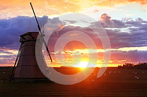 Beautiful Landscape with a Windmill at Sunset