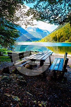 Beautiful landscape. Wooden bench overlooking the lake and mountains. photo