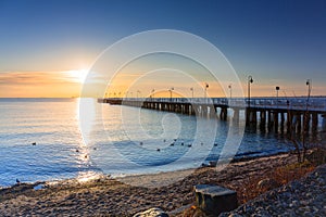 Beautiful landscape with wooden pier in Gdynia Orlowo at sunrise, Poland