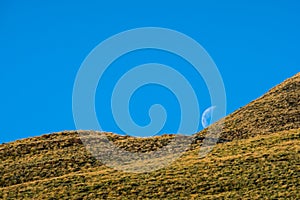 Beautiful landscape of a yellow grassland with blue sky on the high mountain at susnet I