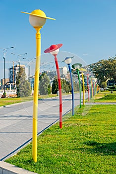 Beautiful lane at Caspian Sea boulevard with colorful funny humanlike lanterns, Baku,