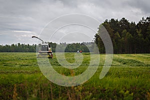 Beautiful lansdscape with haymaking or combine a field