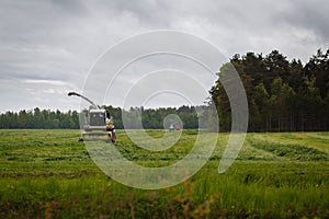 Beautiful lansdscape with haymaking or combine a field