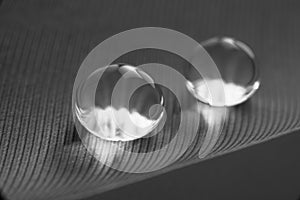 Beautiful large dew drops or rain on the poultry feather closeup