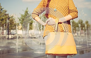 Beautiful large fashionable bag of the girl in her arms. Close up