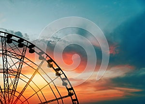 Beautiful large Ferris wheel outdoors at sunset