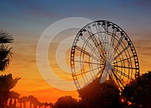 Beautiful large Ferris wheel outdoors at sunset