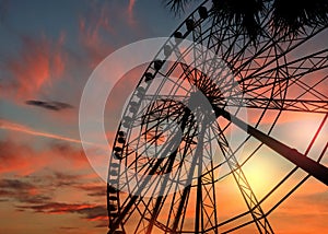 Beautiful large Ferris wheel outdoors at sunset, low angle view