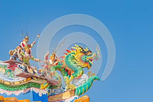 Beautiful large grimace dragons crawling on the decorative tile roof in Chinese temples. Colorful roof detail of traditional Chine