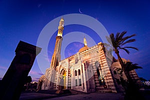 Beautiful large Islamic mosque at the sunset sky background