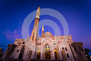 Beautiful large Islamic mosque at the sunset sky background