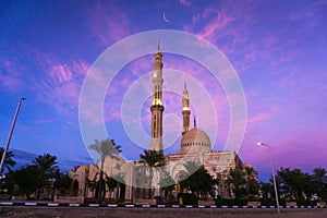 Beautiful large Islamic mosque at the sunset sky background