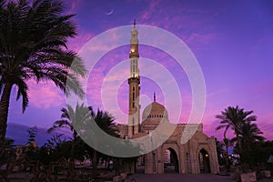 Beautiful large Islamic mosque at the sunset sky background