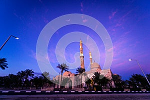 Beautiful large Islamic mosque at the sunset sky background