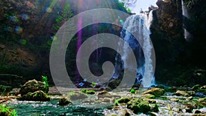 Beautiful large waterfall. Sunbeams and lens flare.