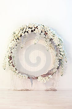 A beautiful large wreath of white flowers on the wall