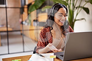 Beautiful latin businesswoman working on laptop during video call