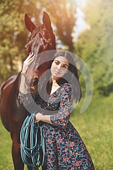 Beautiful Latin woman in dress and her lovely horse walk in the forest. love animals concept. love horses