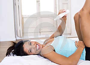 Beautiful latin woman holding pregnancy test looking and finding positive result smiling happy and excited