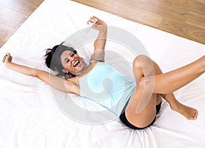 Beautiful latin woman holding pregnancy test looking and finding positive result smiling happy and excited