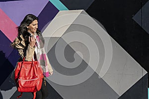 Beautiful latin woman walking down a street. Entrepreneur woman concept