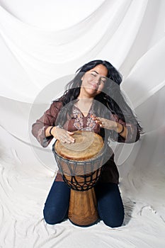 Beautiful Latina playing a Djembe Drum (1)