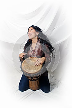 Beautiful Latina playing a Djembe Drum (2)