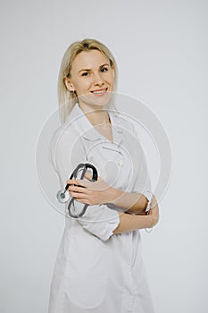 Beautiful laughing female doctor over white - copy space