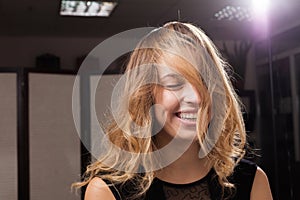 Beautiful laughing young model with hair on a face